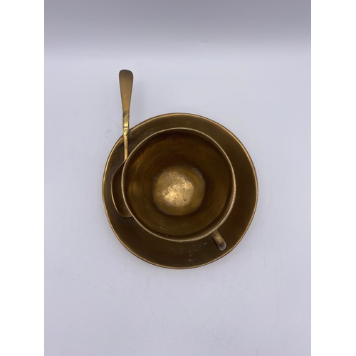 630 - BRASS TEACUP AND SAUCER WITH SPOON