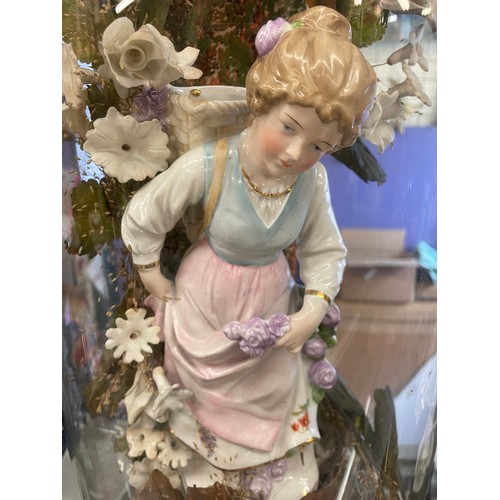 490 - PAIR OF VICTORIAN GERMAN PORCELAIN BOY AND GIRL FIGURE IN FLORAL SETTING UNDER GLASS DOMES