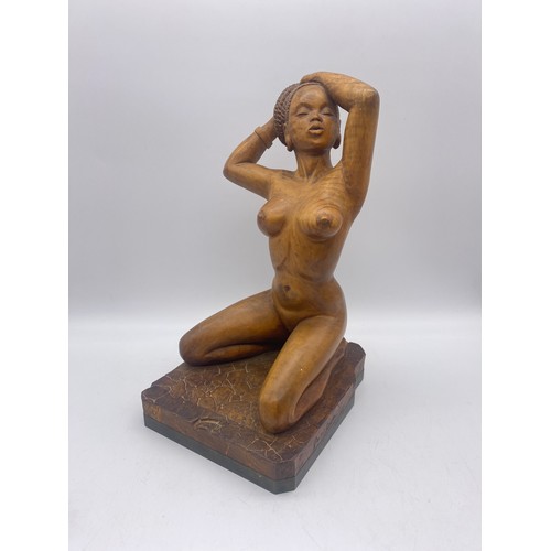 664 - TWO WOODEN CARVINGS OF KNEELING NUDE NUBIAN FEMALES SIGNED GEORGE W DICKER 1960S