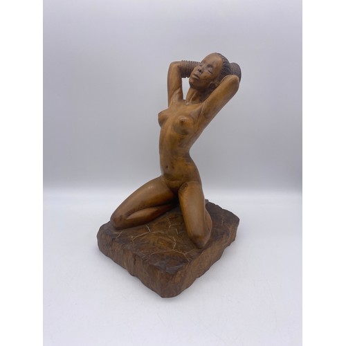 664 - TWO WOODEN CARVINGS OF KNEELING NUDE NUBIAN FEMALES SIGNED GEORGE W DICKER 1960S