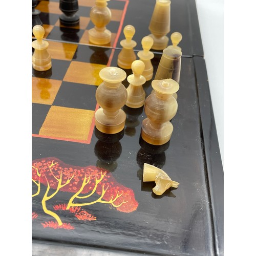 640 - BLACK LACQUERED COMPACT CHESS SET WITH CARVED HORN PIECES A/F