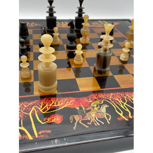 640 - BLACK LACQUERED COMPACT CHESS SET WITH CARVED HORN PIECES A/F