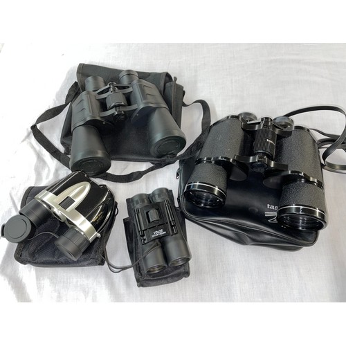 693 - PAIR OF TASCO BINOCULARS 12X50MM AND PAIR OF 20X50 BINOCULARS AND TWO SMALLER POCKET BINOCULARS