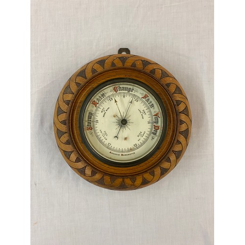 499 - EDWARDIAN ANEROID BAROMETER IN POKER WORK DECORATED ROUNDEL CASE