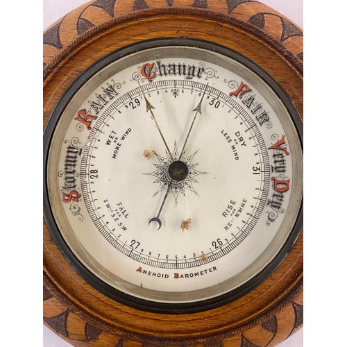 499 - EDWARDIAN ANEROID BAROMETER IN POKER WORK DECORATED ROUNDEL CASE