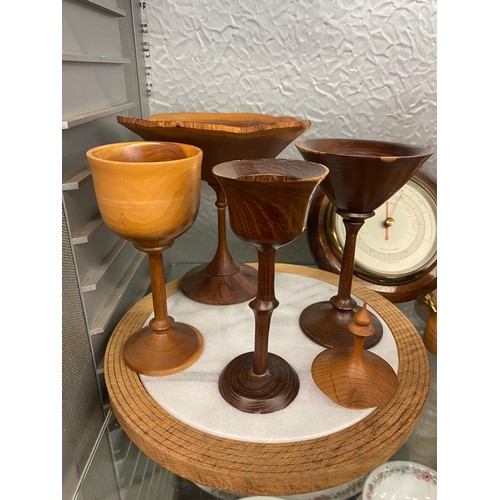 350 - SHELF OF TREEN, TURNED WOODEN GOBLETS, BOWLS, WOODEN MOUNTED CLOCKS, AND BAROMETER