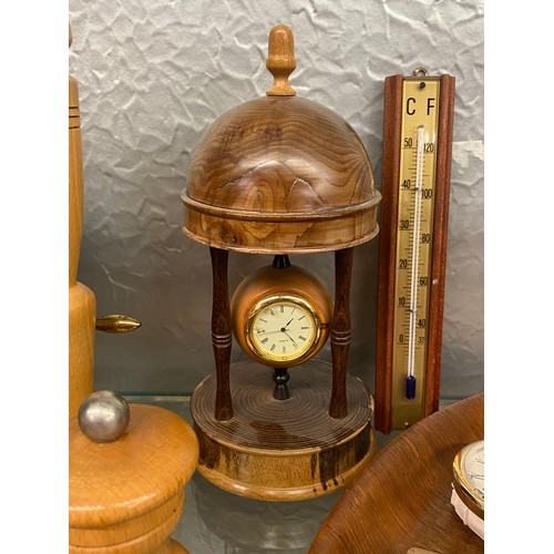 350 - SHELF OF TREEN, TURNED WOODEN GOBLETS, BOWLS, WOODEN MOUNTED CLOCKS, AND BAROMETER