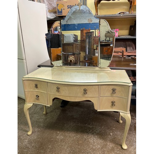 34 - BLEACHED WALNUT SERPENTINE KNEEHOLE DRESSING TABLE WITH TRIPLE MIRROR