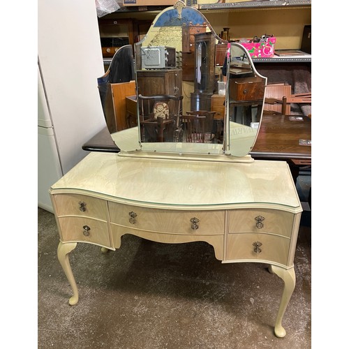 34 - BLEACHED WALNUT SERPENTINE KNEEHOLE DRESSING TABLE WITH TRIPLE MIRROR