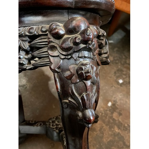 150 - EASTERN HARDWOOD CARVED JARDINIERE STAND WITH LOBED TOP INSET WITH MARBLE PANEL AND CARVED FACEMASK ... 