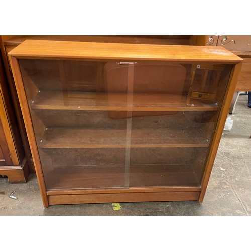 213 - TEAK GLAZED SLIDING DOOR BOOKCASE