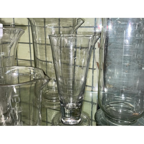 298 - HALF SHELF OF KITCHEN GLASS MEASURING BEAKERS