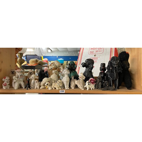 235 - SHELF OF POTTERY AND RESIN DOG FIGURES MAINLY POODLES