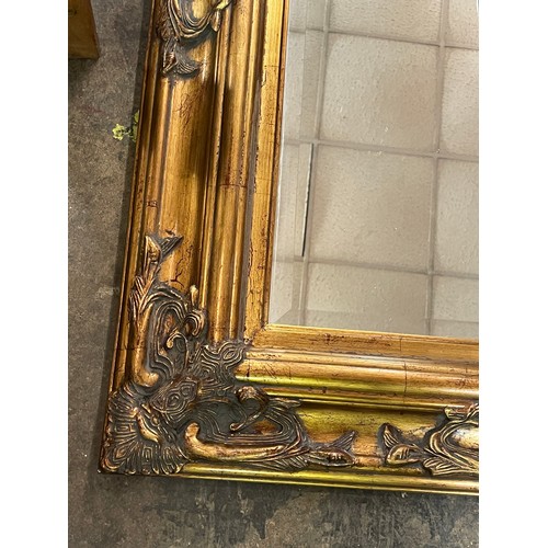 244 - GILT MOULDED STRAP WORK BEVELLED MIRROR