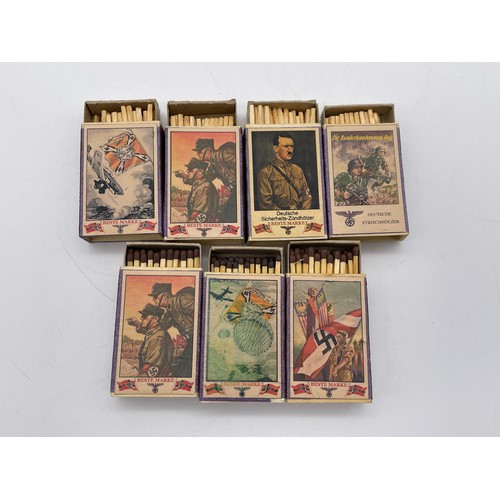 574 - SEVEN WWII GERMAN MILITARY STYLE MATCHBOXES WITH PRINTED COVERS