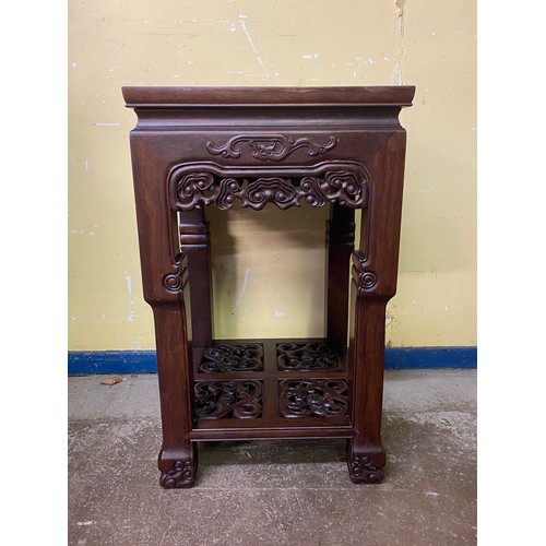 149 - CHINESE HARDWOOD SQUARE SECTION TABLE WITH CARVED AND FRET CARVED FRIEZE AND UNDER TIER