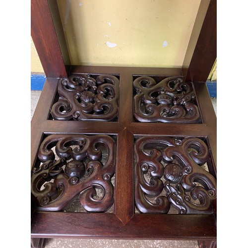 149 - CHINESE HARDWOOD SQUARE SECTION TABLE WITH CARVED AND FRET CARVED FRIEZE AND UNDER TIER