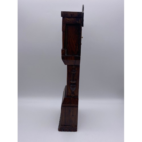 499 - QUARTZ CLOCK IN A CARVED OAK LONG CASE HEIGHT 39CM APPROX