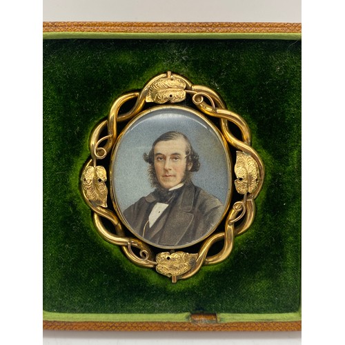 555 - VICTORIAN UNMARKED YELLOW METAL CASED PORTRAIT MINIATURE WITH HAIR LOCKET VERSO HOUSED IN A LEATHER ... 