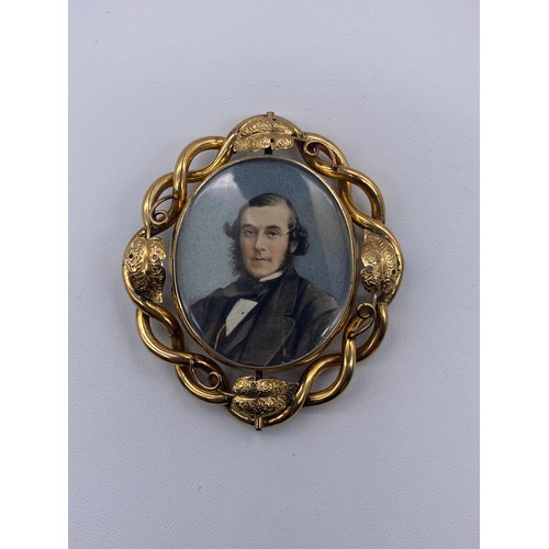 555 - VICTORIAN UNMARKED YELLOW METAL CASED PORTRAIT MINIATURE WITH HAIR LOCKET VERSO HOUSED IN A LEATHER ... 