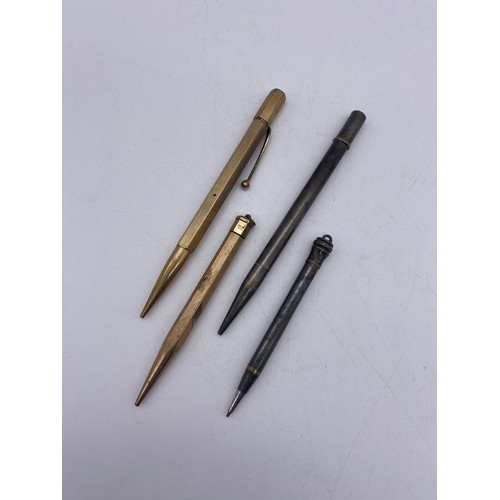 565 - TWO SILVER PROPELLING PENCILS AND TWO ROLLED GOLD EXAMPLES