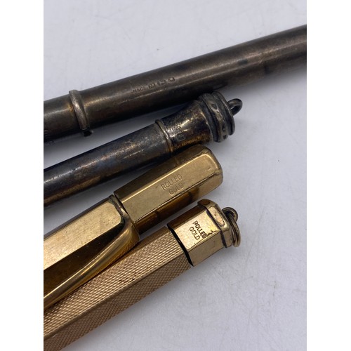 565 - TWO SILVER PROPELLING PENCILS AND TWO ROLLED GOLD EXAMPLES