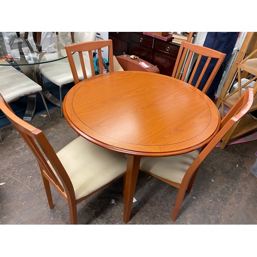 129 - CONTEMPORARY CIRCULAR EXTENDING DINING TABLE AND FOUR CHAIRS