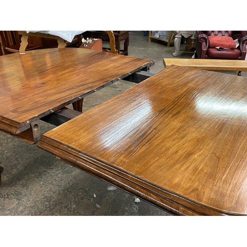 132 - VICTORIAN MAHOGANY D-END EXTENDING DINING TABLE ON FLUTED TAPERED LEGS WITH BRASS CASTORS