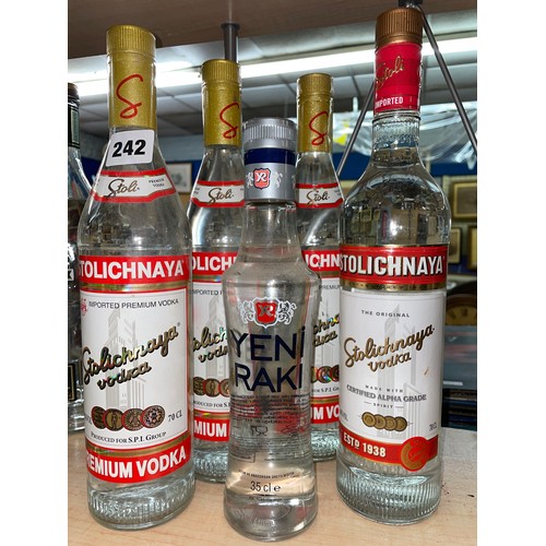 242 - FOUR BOTTLES OF STOLICHNAYA PREMIUM VODKA AND A BOTTLE OF YENI RAKI