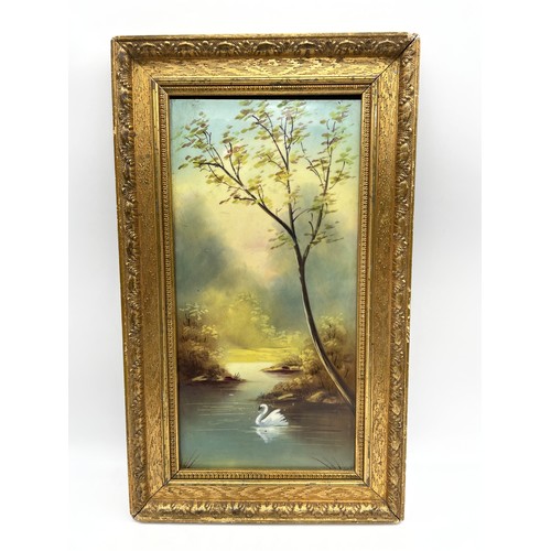 648 - 19TH CENTURY OILS ON CERAMIC TILE RIVER LANDSCAPE WITH SWAN IN GILDED FRAME 15CM X 30CM APPROX