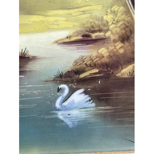 648 - 19TH CENTURY OILS ON CERAMIC TILE RIVER LANDSCAPE WITH SWAN IN GILDED FRAME 15CM X 30CM APPROX