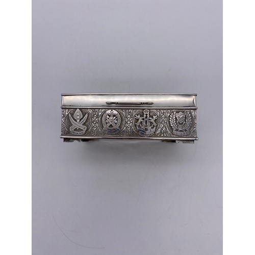 519 - WHITE METAL RECTANGULAR CIGARETTE BOX WITH REPOUSSE DECORATION AND ARMORIAL CREST PRESENTATION INSCR... 