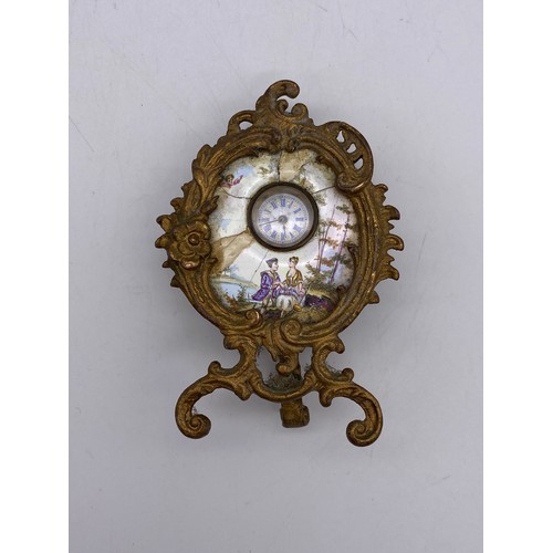 634 - GILT METAL CASED PORCELAIN TIME PIECE IN THE ROCOCO STYLE