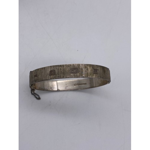 616 - SILVER ENGRAVED BANGLE AND ONE OTHER WITH SAFETY CHAIN 42G OVERALL