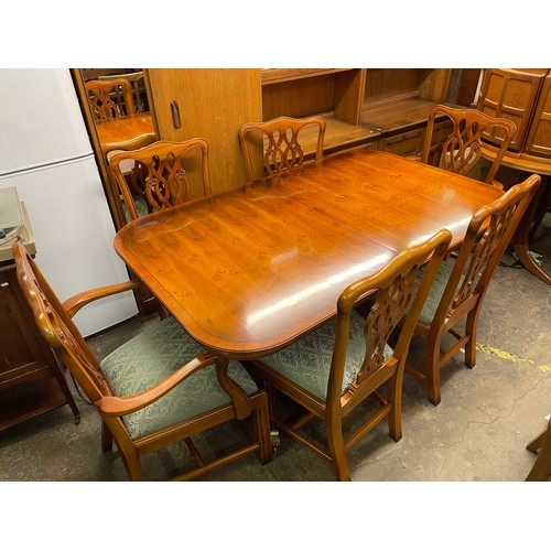 152 - REPRODUCTION YEW CROSS BANDED EXTENDING DINING TABLE AND SIX CHIPPENDALE DESIGN CHAIRS