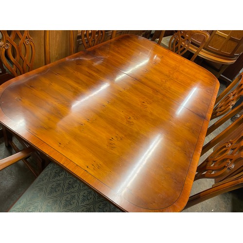 152 - REPRODUCTION YEW CROSS BANDED EXTENDING DINING TABLE AND SIX CHIPPENDALE DESIGN CHAIRS