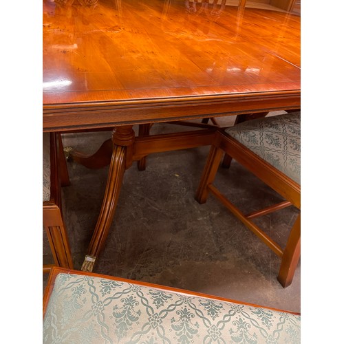 152 - REPRODUCTION YEW CROSS BANDED EXTENDING DINING TABLE AND SIX CHIPPENDALE DESIGN CHAIRS