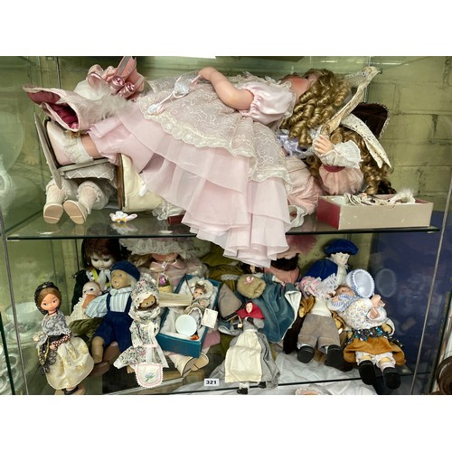 321 - TWO SHELVES OF MAINLY PORCELAIN HEADED DRESS DOLLS AND OTHERS