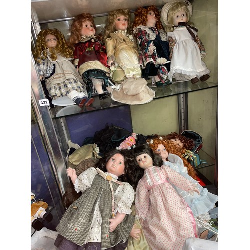 322 - ELEVEN PORCELAIN HEADED DOLLS