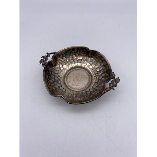 439 - STAMPED 900 BEATEN WHITE METAL SHALLOW DISH WITH ROSE HANDLES