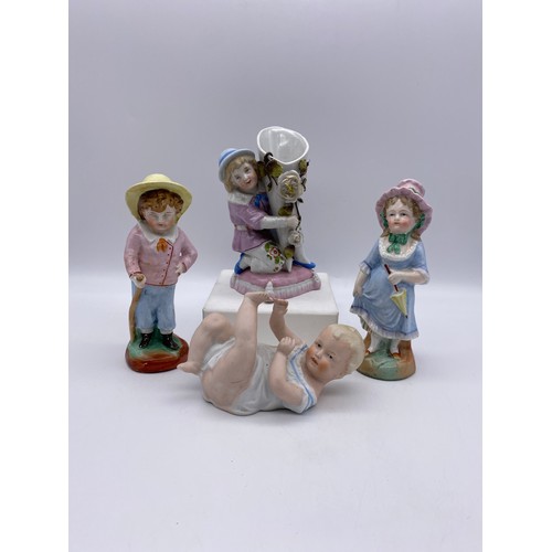 489 - PAIR OF CONTINENTAL BOY AND GIRL FIGURES, BISQUE PIANO BABY, AND A VICTORIAN FAIRING KNEELING BOY WI... 