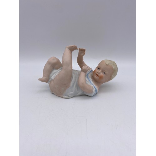 489 - PAIR OF CONTINENTAL BOY AND GIRL FIGURES, BISQUE PIANO BABY, AND A VICTORIAN FAIRING KNEELING BOY WI... 