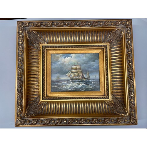 562 - 20TH CENTURY OIL ON PANEL OF SAILING SHIP WITH SMACK ALONGSIDE IN ORNATE GILDED HEAVY FRAME