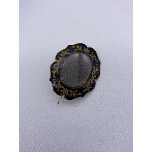 532 - LOBED BLACK ENAMEL AND HAIR LOCKET MOURNING BROOCH