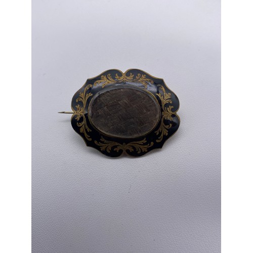 532 - LOBED BLACK ENAMEL AND HAIR LOCKET MOURNING BROOCH