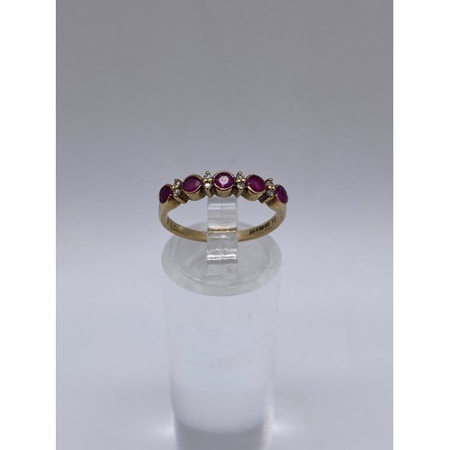 528 - 9CT GOLD CZ AND RUBY CHANNEL RING SIZE M 1.7G APPROX