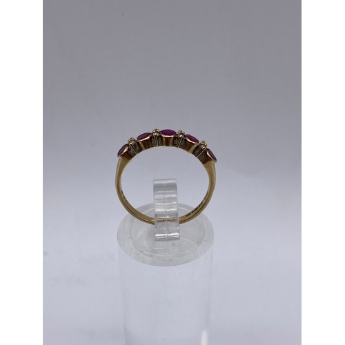 528 - 9CT GOLD CZ AND RUBY CHANNEL RING SIZE M 1.7G APPROX