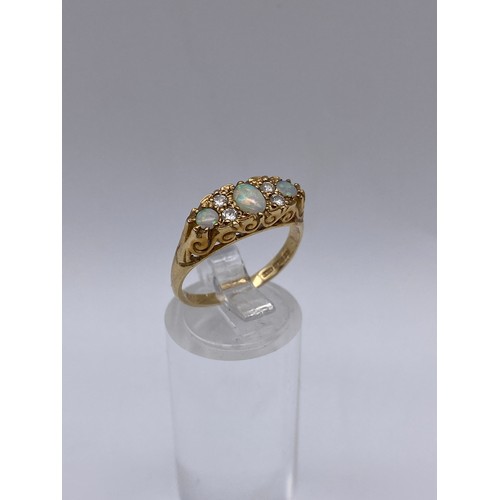 531 - 9CT GOLD THREE STONE OPAL AND DIAMOND CHIP RING SIZE N/O 2.7G APPROX