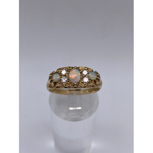 531 - 9CT GOLD THREE STONE OPAL AND DIAMOND CHIP RING SIZE N/O 2.7G APPROX