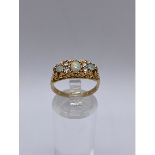 531 - 9CT GOLD THREE STONE OPAL AND DIAMOND CHIP RING SIZE N/O 2.7G APPROX